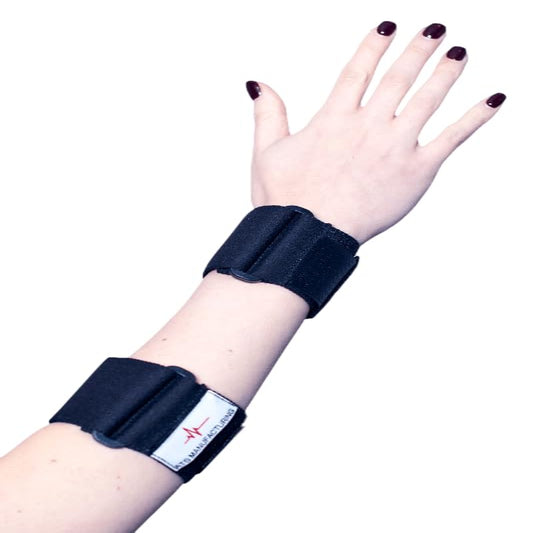 A black elbow splint brace being worn on a person's left arm, featuring a red cross logo.