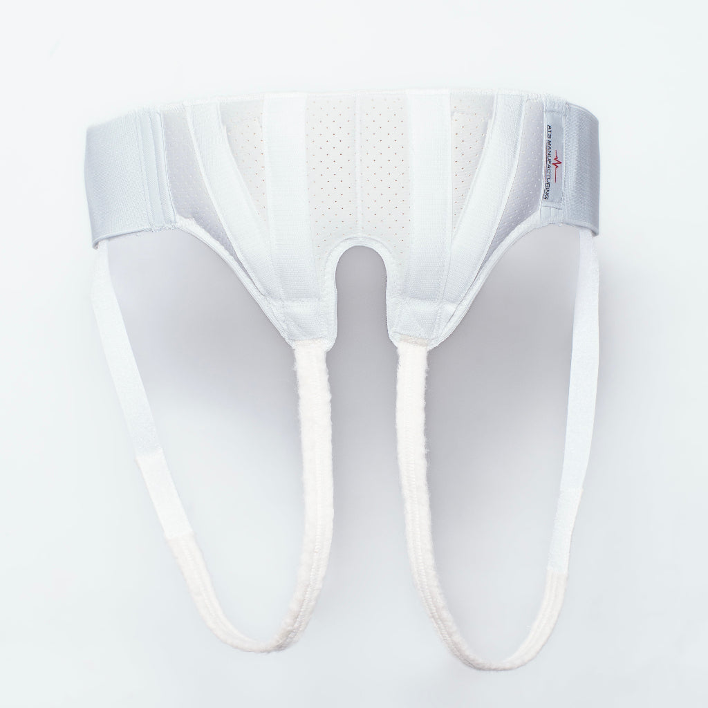 A white surgical hernia truss designed to provide support for a groin hernia.